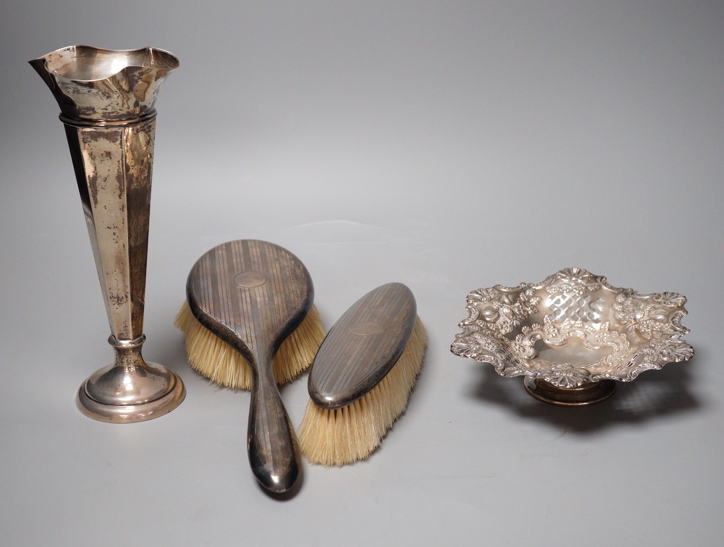 A late Victorian pierced silver pedestal bon bon dish, London, 1898, a silver mounted specimen vase and two silver backed brushes
